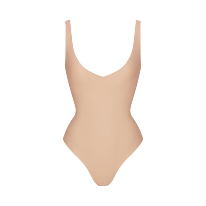 SKIMS BODY UNLINED PLUNGE THONG BODYSUIT | CLAY